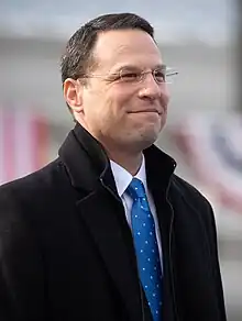 Shaprio pictured with glasses and suit, smiling