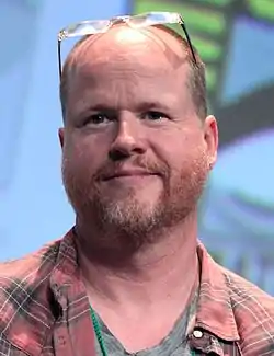 A picture of a man with glasses on his head looking toward the camera