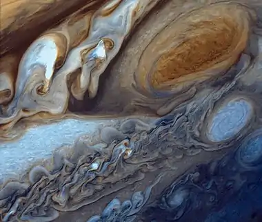 Image 8Great Red SpotPhoto credit: Voyager 1False-color detail of Jupiter's atmosphere, imaged by Voyager 1, showing the Great Red Spot and a passing white oval. The wavy cloud pattern to the left of the Red Spot is a region of extraordinarily complex and variable wave motion. To give a sense of Jupiter's scale, the white oval storm directly below the Great Red Spot is approximately the same diameter as Earth.More selected pictures