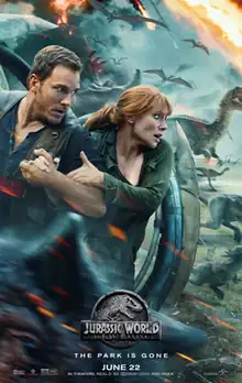 A man and a woman take cover behind a spherical vehicle, while various dinosaurs run from an erupting volcano.