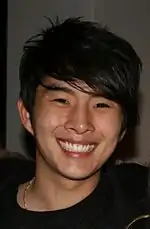 Photo of the actor Justin Chon, smiling.