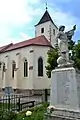 The Szent Kereszt-templom (English: Holy Cross Church) with the monument for those who died in the Second World War or in the Revolution of 1956