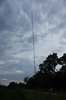 A very tall tower in silhouette against a blue sky