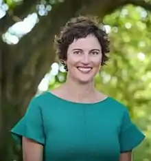 Woman wearing teal smiling at camera