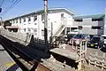 The driver changeover platform for up services and the staff dormitory block next to the station in February 2012