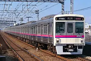 White commuter train with purple stripe