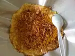 Kerak telor with fried shallots on top.