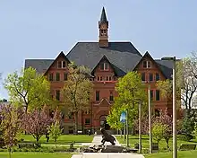 Looking south on the campus of Montana State University in Bozeman, Montana, USA. Montana Hall sits in the background with Alumni Plaza and a bronze sculpture of Spirit the Bobcat in the foreground. Photo by Kelly Gorham