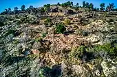 The remains (stone clusters) above and below the path the transcends nowadays through the village remains