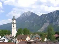 Church of the Holy Cross in Kiefersfelden with Kaiser Mountains in the background