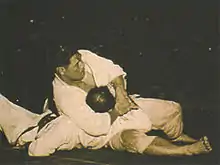 Image 22Masahiko Kimura vs. Hélio Gracie, a 1951 bout between Japanese judo fighter Masahiko Kimura and Brazilian jiu jitsu founder Hélio Gracie in Brazil, was an early high-profile mixed martial arts bout. (from Mixed martial arts)