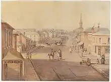 An orderly townscape with houses of two stories and the Church towards the end of the street. People are riding and walking in the street.