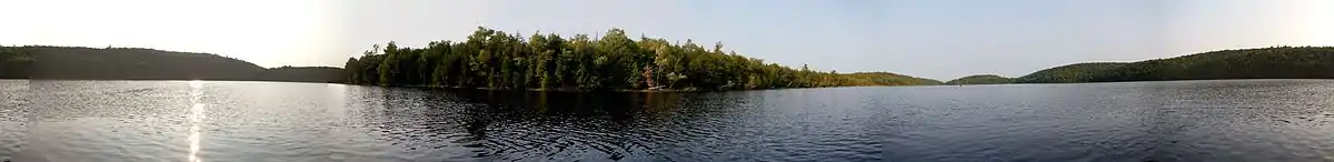 An almost completely isolated lake, Kishkebus Lake, at Bon Echo Provincial Park, but for a small waterfall at the south-east draining into Shabomeka Lake.