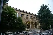 Large, old building with trees and arched entrance