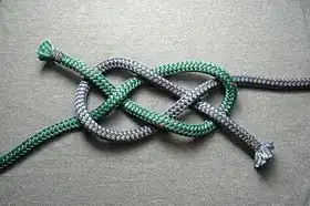 Tying starts  with a diagonal carrick bend (two colors for clarity)