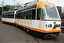 Two-car, white-and-orange tram