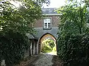 Gothic pointed arch door with bevel profile in the sandstone ground floor (Kortenberg)