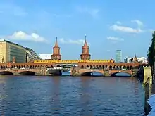 Yellow train crossing a river