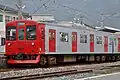 JR Kyushu 103–1500 series in revised livery, April 2006