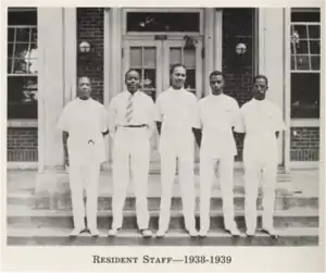 Medical residents posing in front of the hospital.