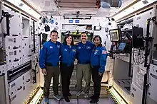 Inside the Lunar Gateway mock-up module, with four astronauts.