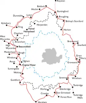 An outline map of the area around London. A series of concentric jagged lines donate various areas. Outermost is a red ring which is the area within which the LPTB controlled transport services. Within this are a dashed black line (area of monopoly powers), a dashed blue ring (Metropolitan Police District) and a grey shaded area (County of London). The names of towns around the perimeter of the red ring indicate its extent.