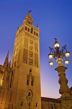 Image 18GiraldaPhoto: David IliffThe Giralda is a 104.5 m (343 ft) tall bell tower for the Seville Cathedral in Seville, Andalusia, Spain. It was originally constructed as a minaret in 1198, when Seville was ruled by the Almohad Caliphate. After the city was taken by the Christians in the Reconquista, the city's mosque was converted to a church. The upper third of the structure was completed during the Spanish Renaissance.More selected pictures