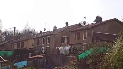 Rows of four houses seen from a low angle.