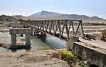 The Manatuto Bridge under construction in 2018, with the 1984 bridge at right