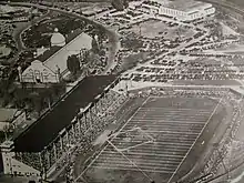 Black and white aerial view of a football stadium with the surrounding exhibition grounds