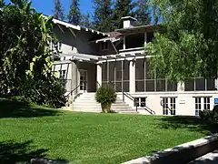 Roof massing and supports are typical of wood-frame bungalow construction of the 1910s.