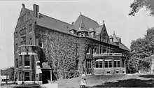 A picture of Lathrop Hall, covered in ivy, around 1905, prior to its usage by the Department of Music and subsequent demolition in the 1960s