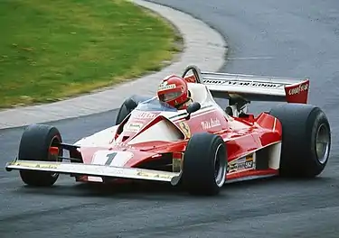 Niki Lauda driving the Ferrari 312T at the 1976 German Grand Prix. By this time, the Ferrari livery included the logos of team suppliers such as Goodyear and Agip.