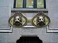 Lion heads on the windows of the mailboxes in García Camba Street