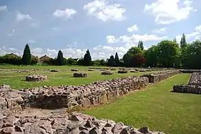 A contemporary photograph showing the low stone walls which plot the layout of the abbey's nave and cloisters.