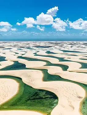 Image 2Lençóis Maranhenses National ParkPhotograph: Julius DadaltiLençóis Maranhenses National Park (Parque Nacional dos Lençóis Maranhenses) is a national park located in Maranhão state, in northeastern Brazil, just east of the Baía de São José. Protected since June 1981, the 383,000-acre (155,000 ha) park includes 70 km (43 mi) of coastline, and an interior of rolling sand dunes. During the rainy season, the valleys among the dunes fill with freshwater lagoons, prevented from draining due to the impermeable rock beneath. The park is home to a range of species, including four listed as endangered, and has become a popular destination for ecotourists.More selected pictures