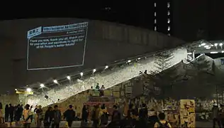 Lennon Wall with a projected message from "Add Oil Machine"