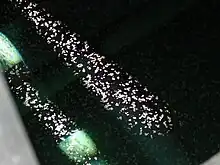 Photo showing calcite rafts on surface of water in Carpinteria Reservoir