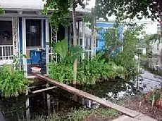 A house with flooding that surrounds the house like a river