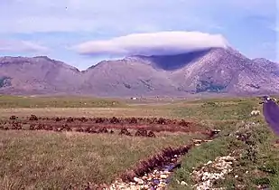 Letterbreckaun (right, in cloud) with the v-shaped pass of Maam Turk (left)