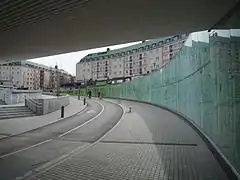 Glass artwork covers the walls of the tunnel