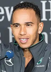 Lewis Hamilton speaking to the media at a car event