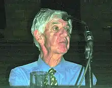 Wolpert sitting behind a microphone