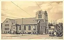 A postcard featuring an photograph of a stone church with a clock tower built into its front. An inscription reads "Baptist Church, Lewiston, Maine."