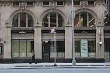 Arches at the base of the facade as seen from Lexington Avenue. The first story of each arch contains storefronts, and the arches are divided into three panes at the second story.