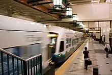 Light rail train arriving at Westlake station's platform