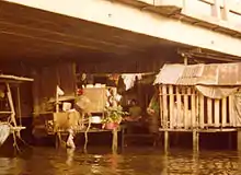 Shack built out of metal and wood under bridge