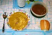 Locro at the table, with quiquirimichi and bread.