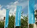 Flags like these in Piccadilly Gardens, Manchester were installed across the UK in green, magenta, orange and blue.