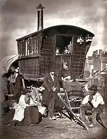 London Nomades, from Thomson's 1877 book Street Life in London, which features Mary Pradd sitting on a caravan's steps